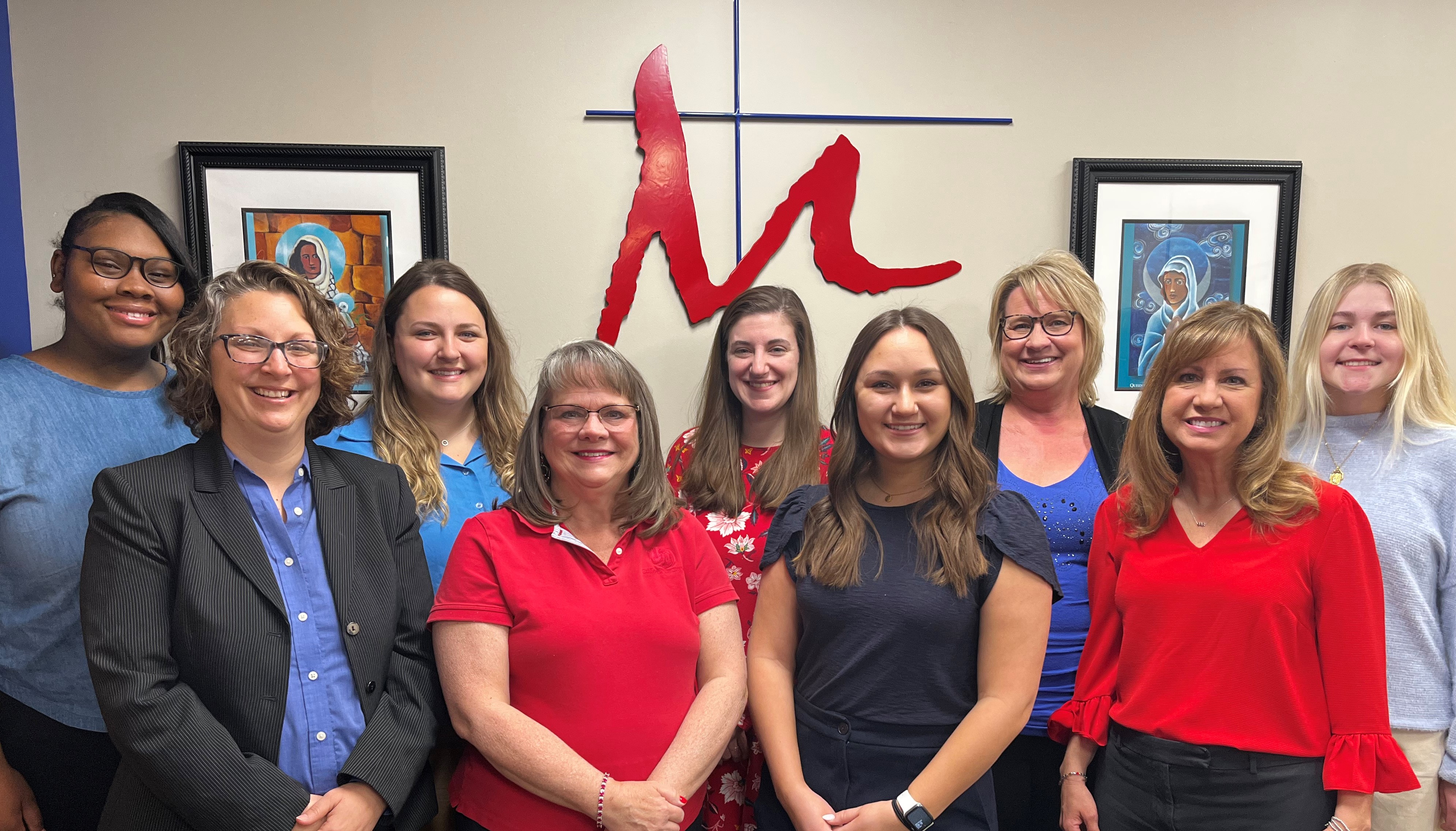 Photo of Flyer Student Services staff in red and blue. From left to right: Seaniece, Catherine, Lilly, Karen, Megan, Jillian, Tricia, Christine and Elle