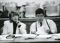 Two students sitting in a courtroom.