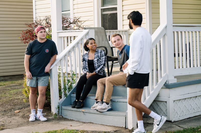 students talking around a porch