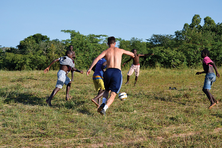 A soccer game on a dry field