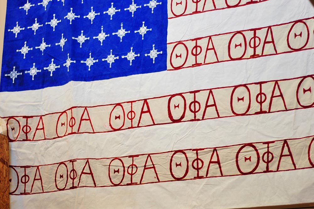 Four out of the five residents are in Theta Phi Alpha, the other they call an "honorary Theta Phi." This hand painted flag was wasting away in a basement box at the sorority house, so they took it out of retirement and hung it for all to see when they walk in the front door.