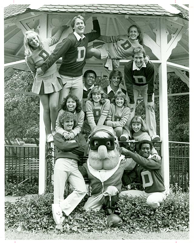 Rudy Flyer poses with the cheerleaders