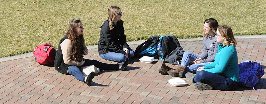 Four friends gathered on Central Mall in the February weather.
