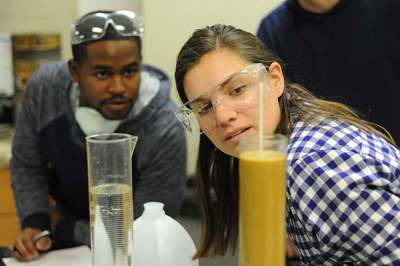 A student taking a reading from the hydrometer.
