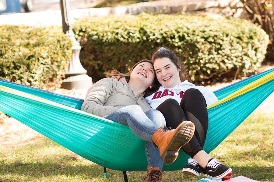 Students swing in hammock.