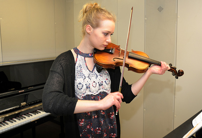 Student practicing violin.