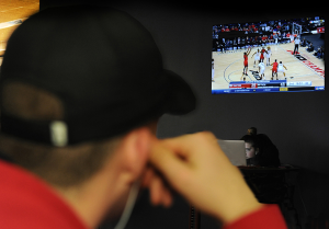 Student watches UD basketball.