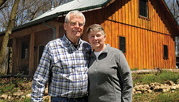Phil Doepker and his wife in front of the house they built