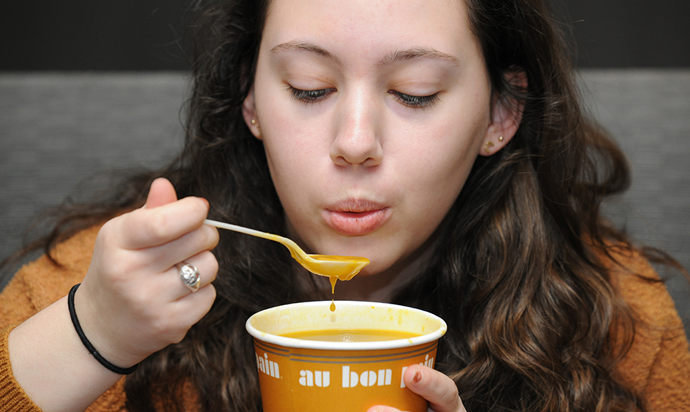 Student eats soup in Kennedy Union.