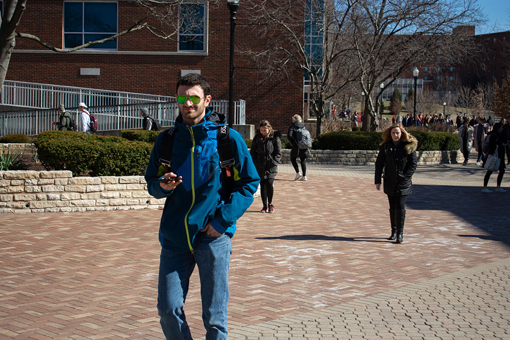 student walks in sunglasses 