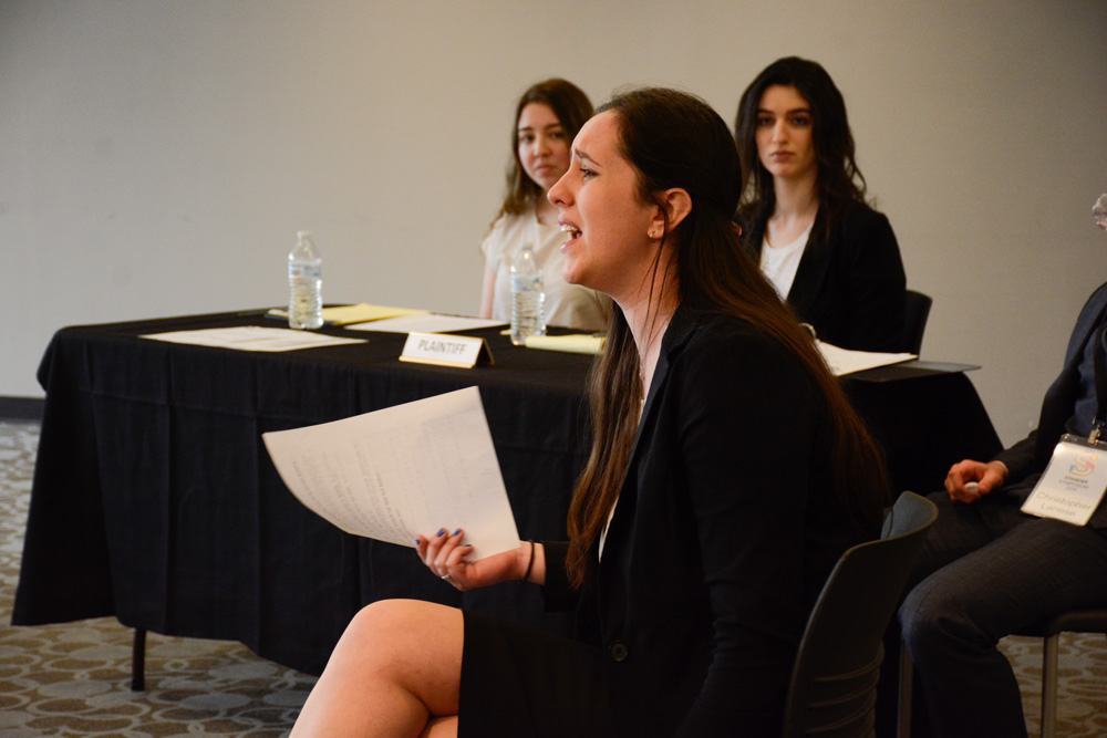A student plays a witness in a mock trial.
