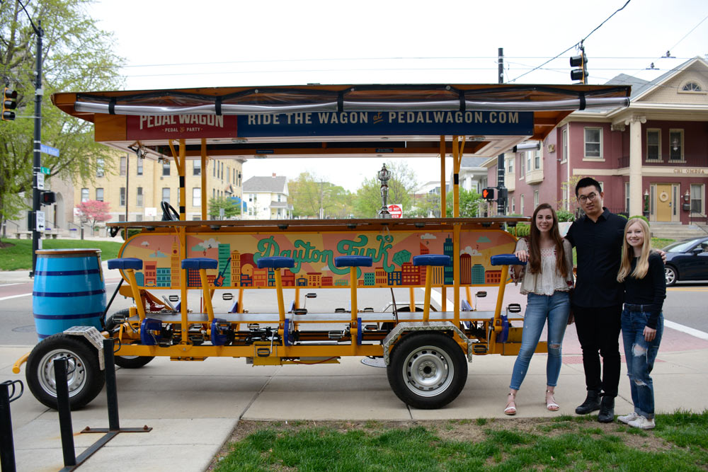 Students stand with the Dayton Pedalwagon.