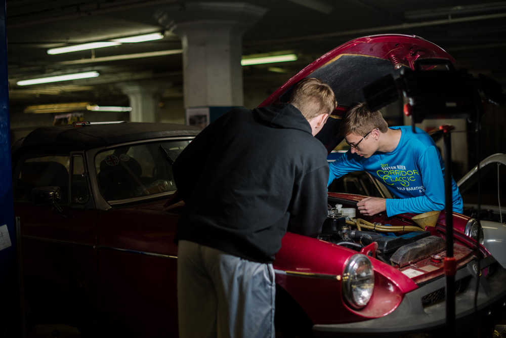 Students work on car