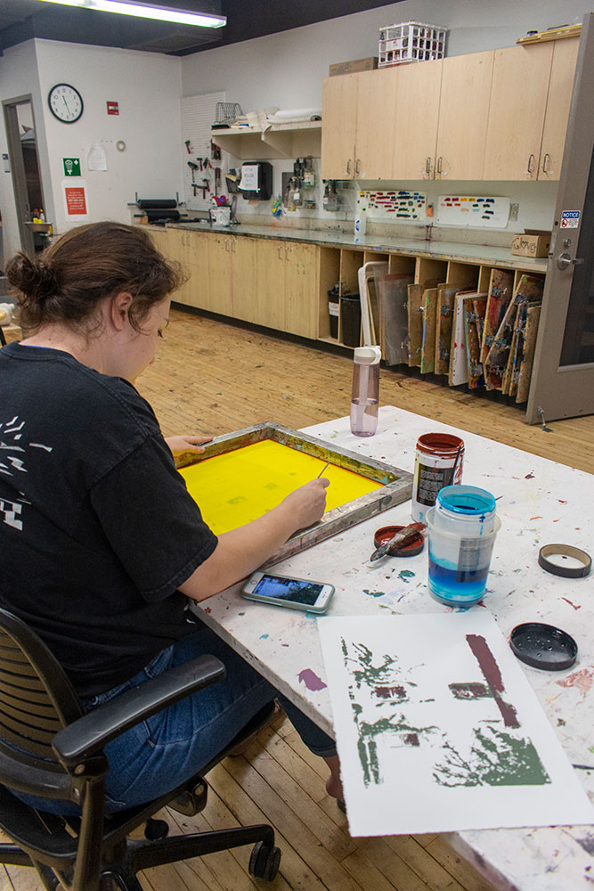 Student works on a screen print