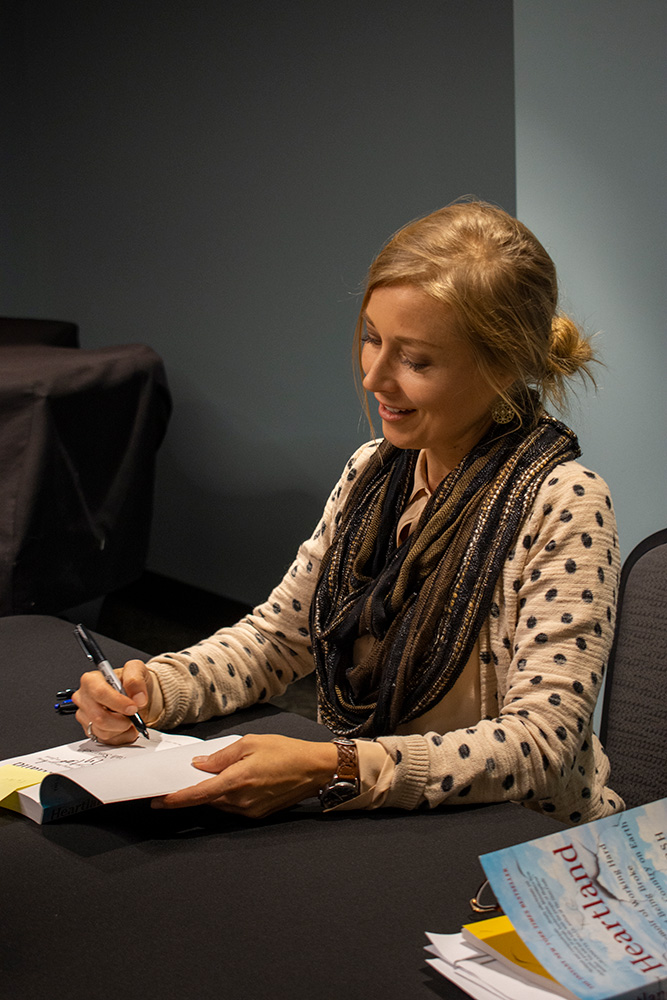 Sarah signs books