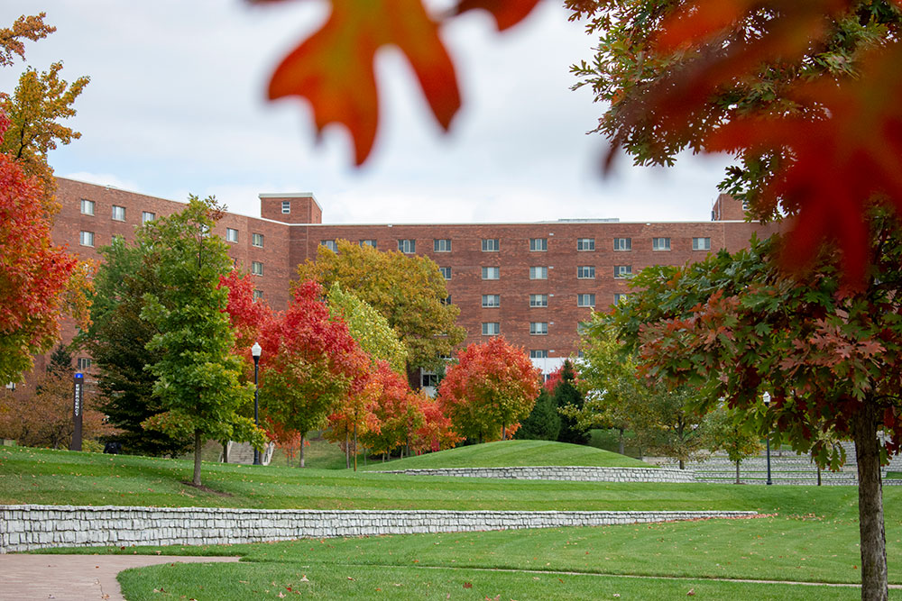 changing leaves in front of residence hall