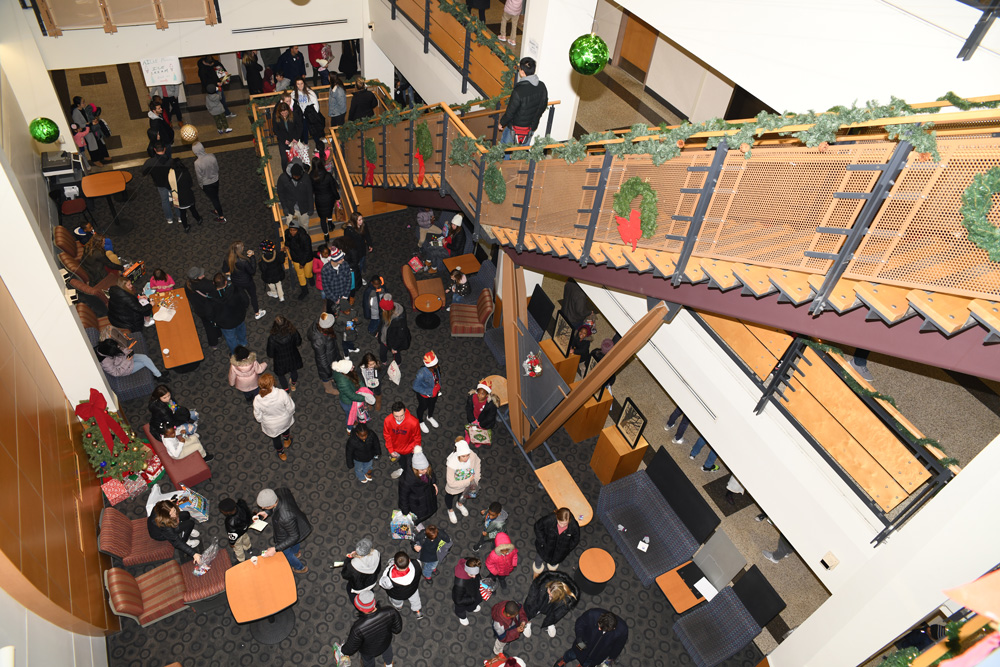 View from the second floor down into an atrium filled with children and students