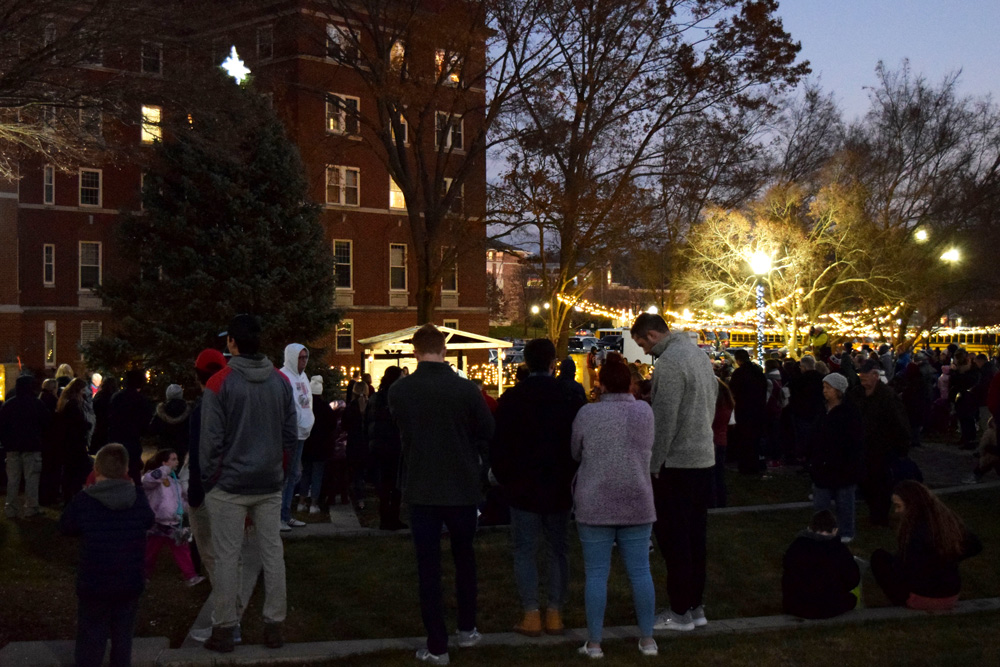 Crowd in Humanities Plaza with Christmas lights in the background