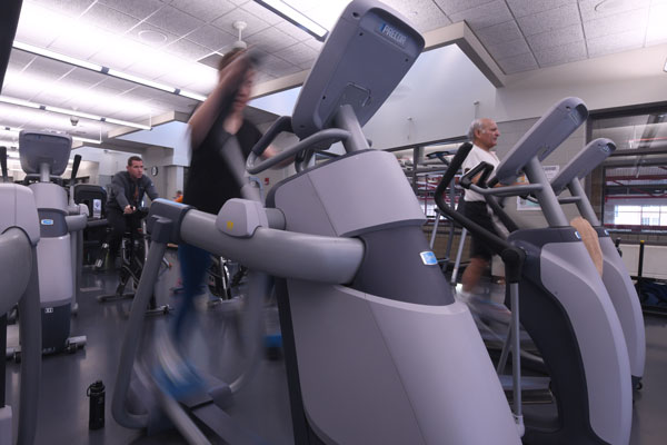 People exercise on fitness machines
