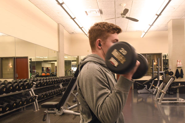 Student lifts hand weights