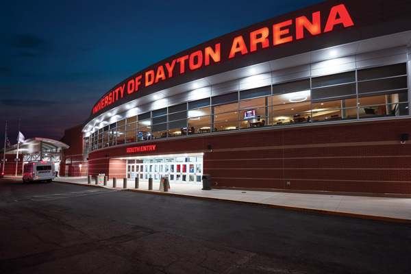 Outside of UD Arena with its name illuminated in red against the night sky. By Devyn Gusta
