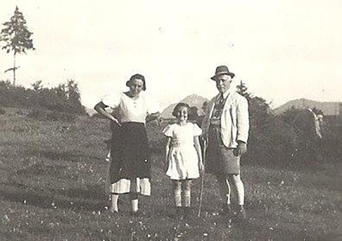 A family poses in a meadow