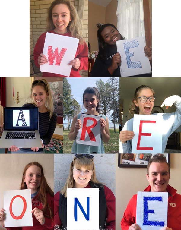 Students holding signs spelling We Are One