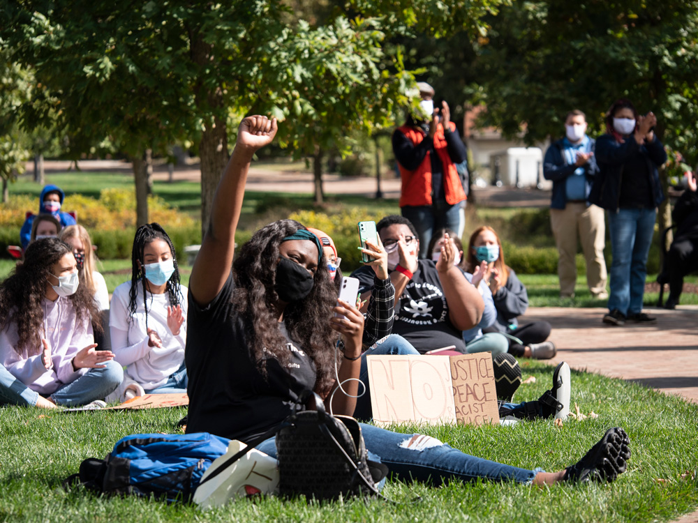 Student raises her fist in solidarity