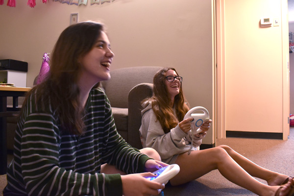 Two female students play video games