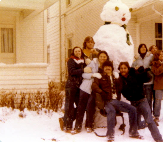 Students gather around a huge snowman