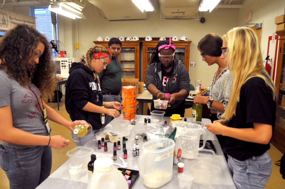 Female students at a work bench in a lab