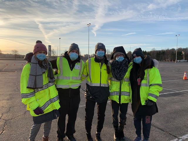 Five students in masks and reflective jackets