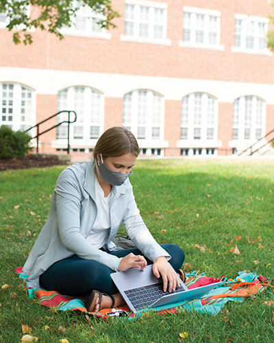 girl on campus with laptop