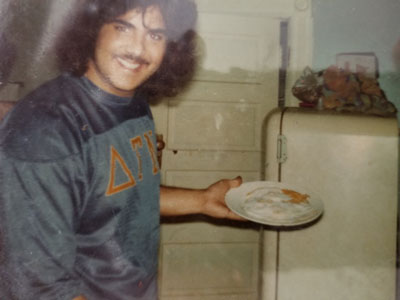 A Delt brother holds a plate of eggs