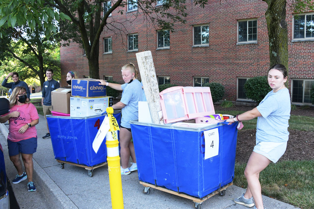 Student volunteers push carts