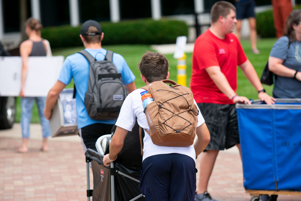 Student pushes a cart full of belongings