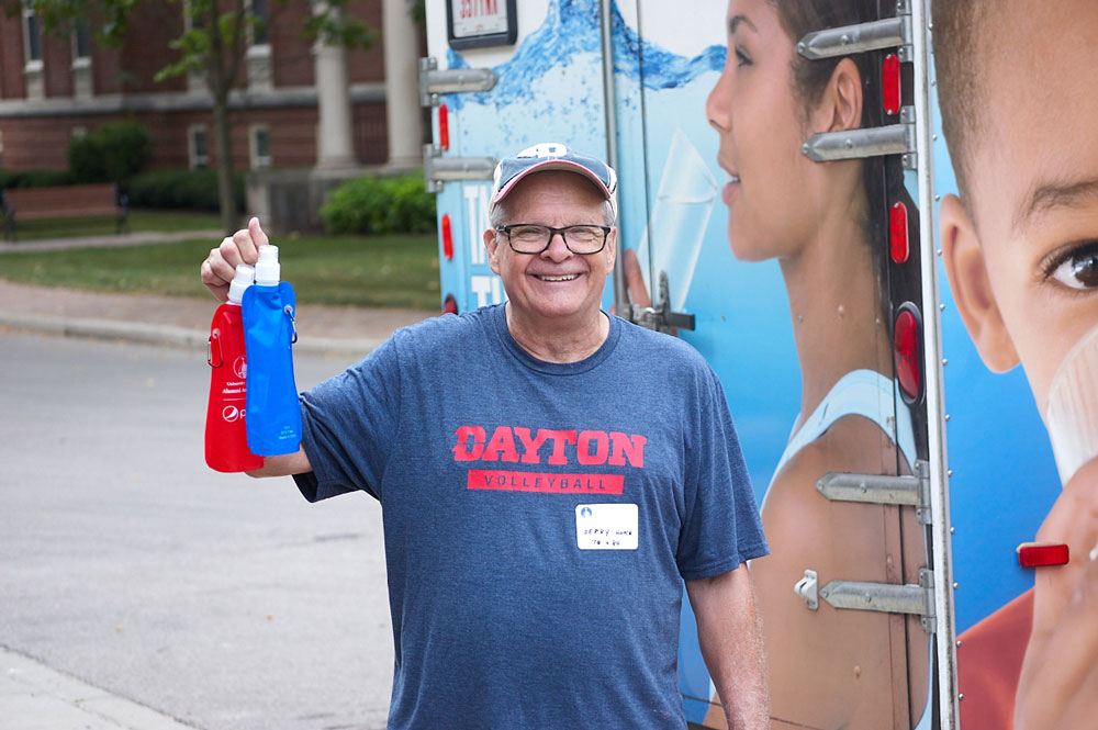 A man holds up water bottles
