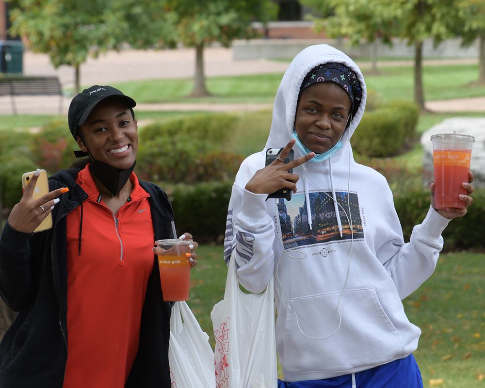 students smiling and wearing fall clothing