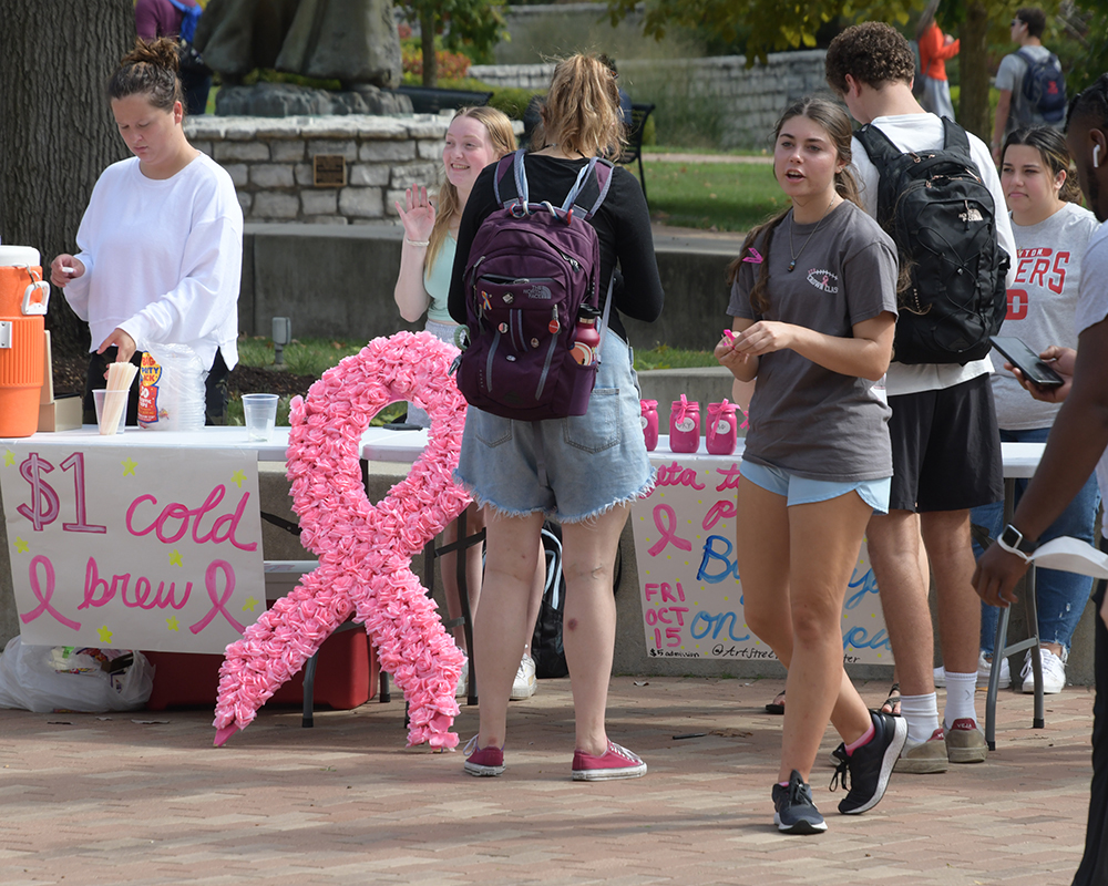 Students handing out breast cancer ribbons