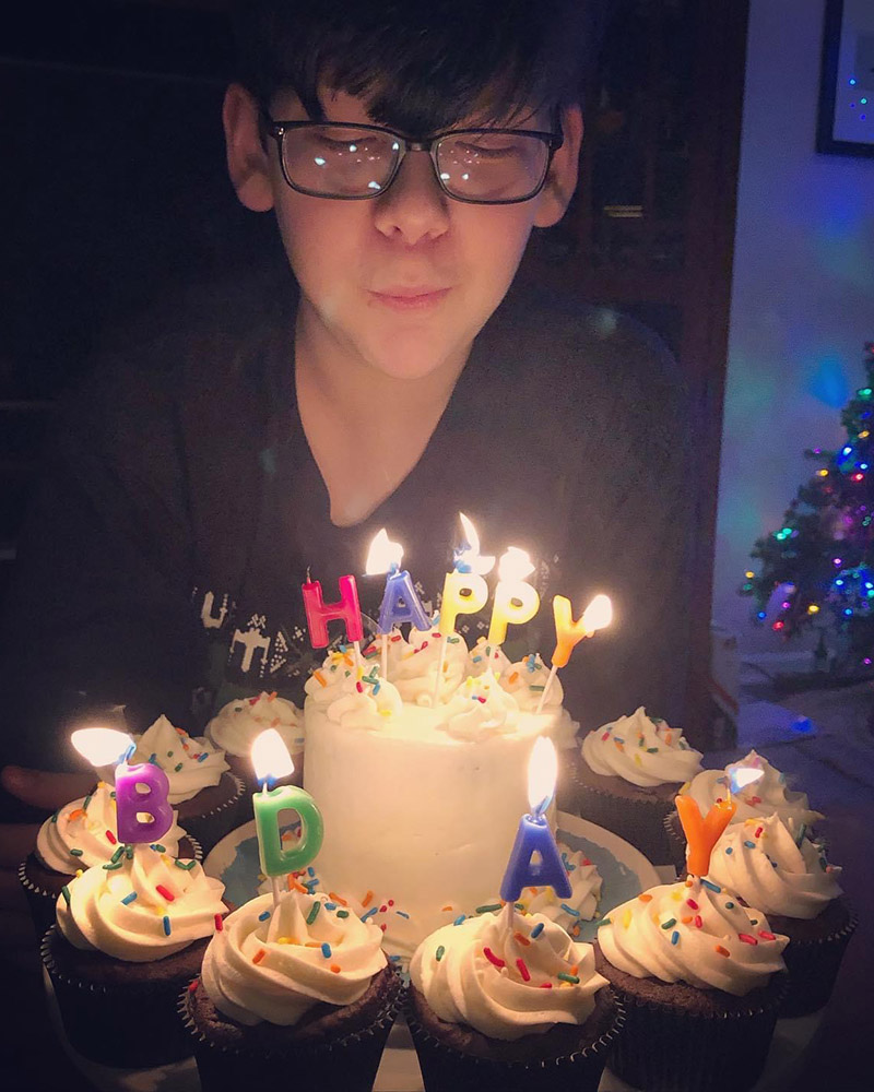 boy blowing out birthday candles