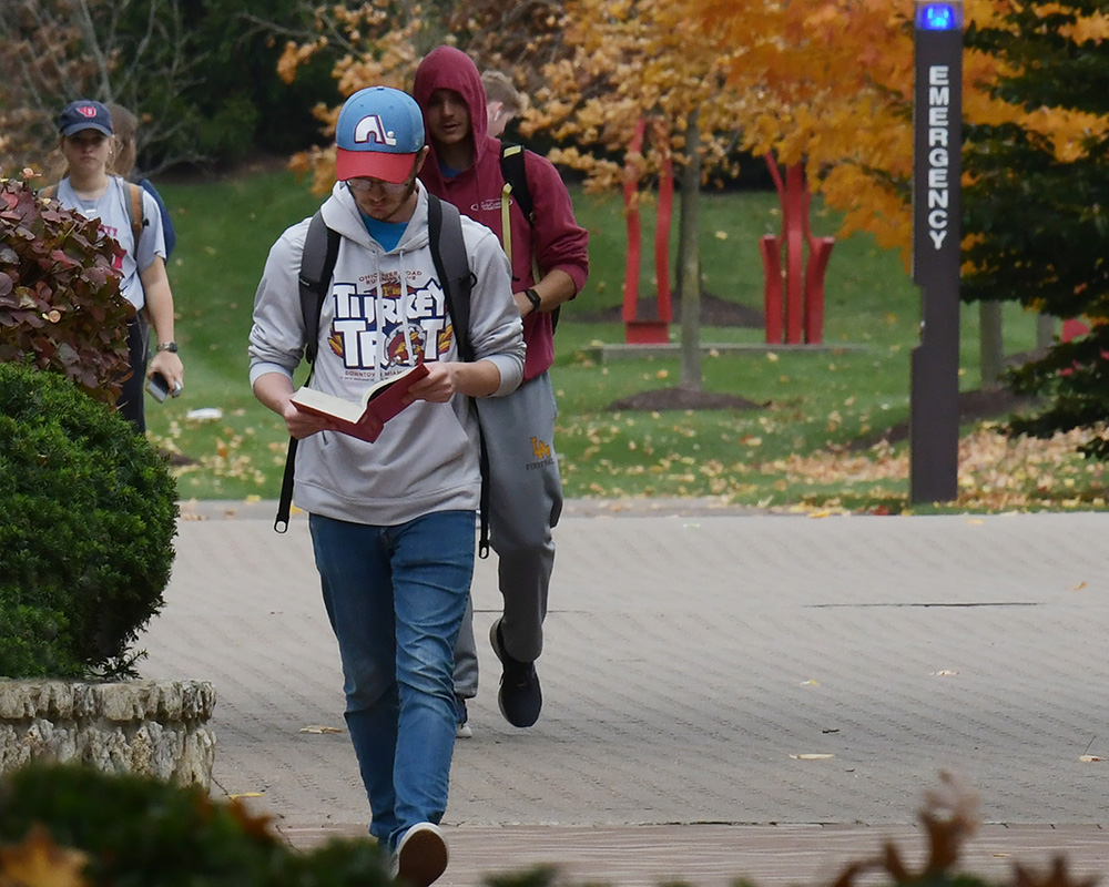 Students walking on a windy, fall day