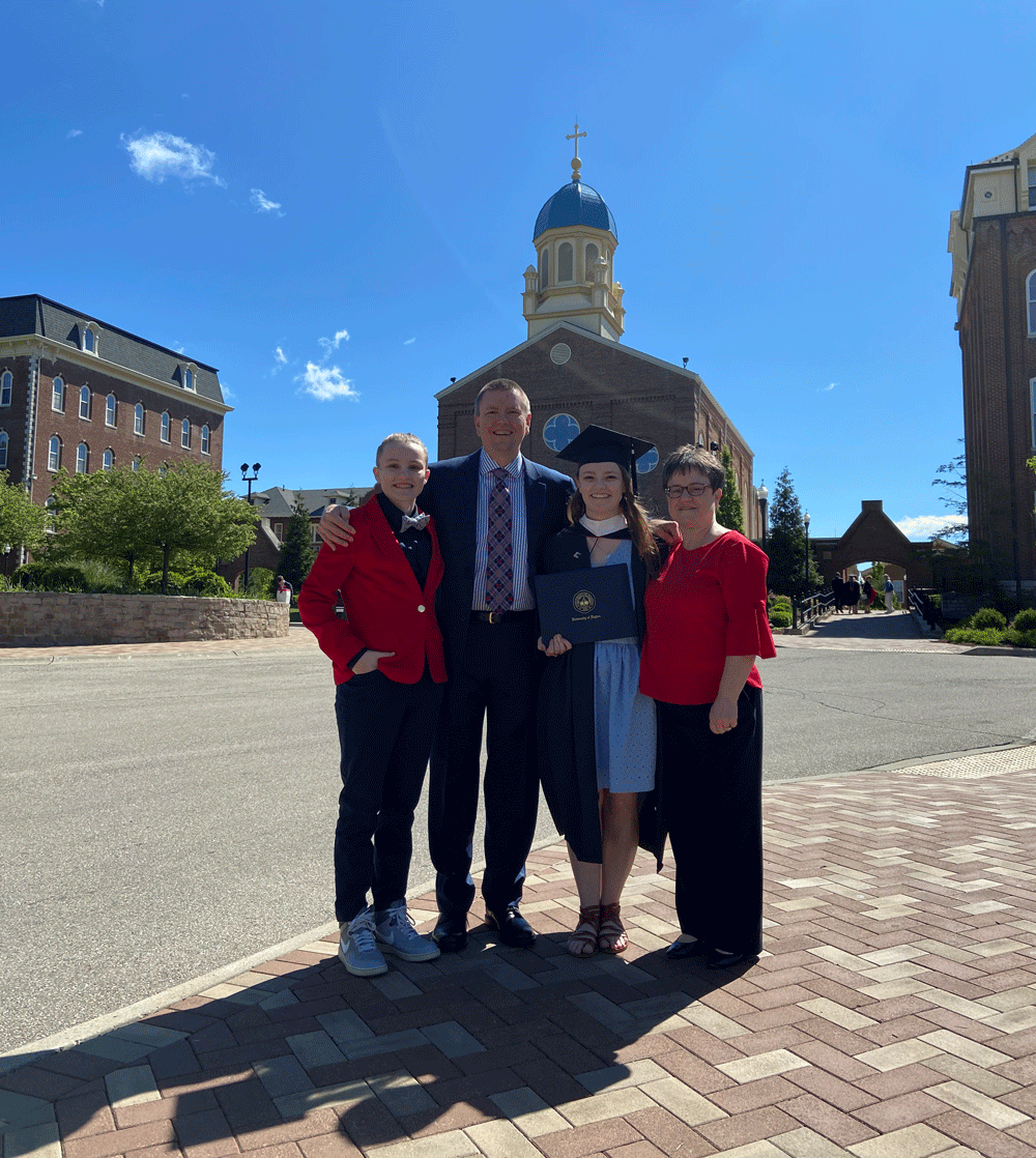 Mary Kate Newman's family standing in front of the UD Chapel.