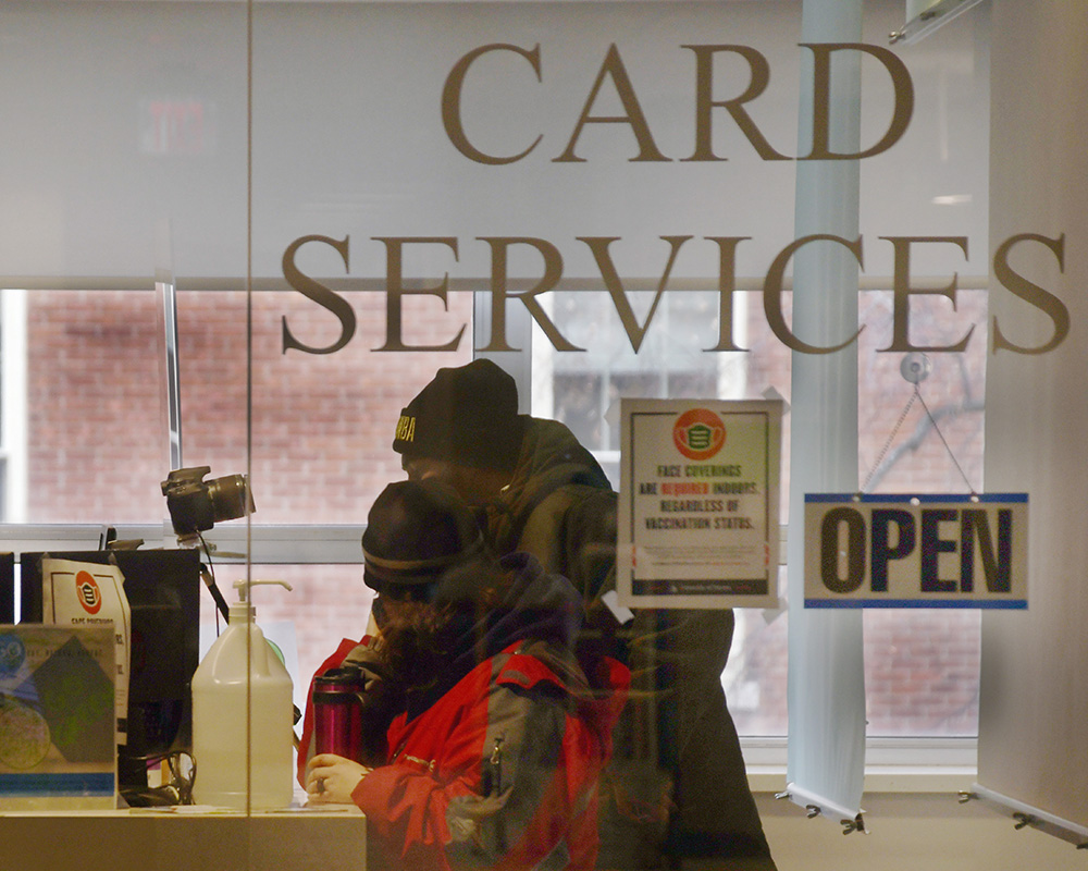 Two students at the card services counter