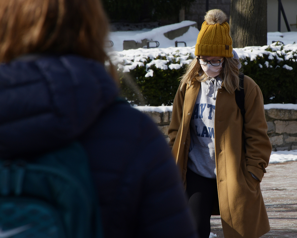 Students outside in winter coats and hats