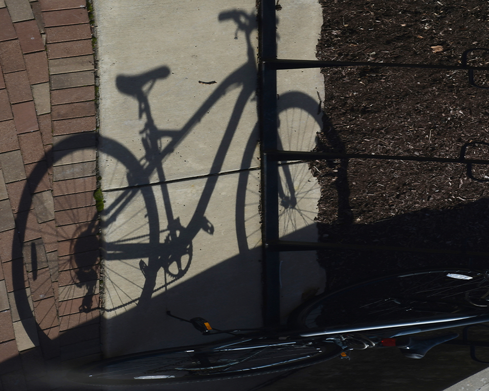 Shadow of a bicycle on the sidewalk