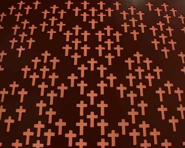 A detail of a cross pattern on a piece of art