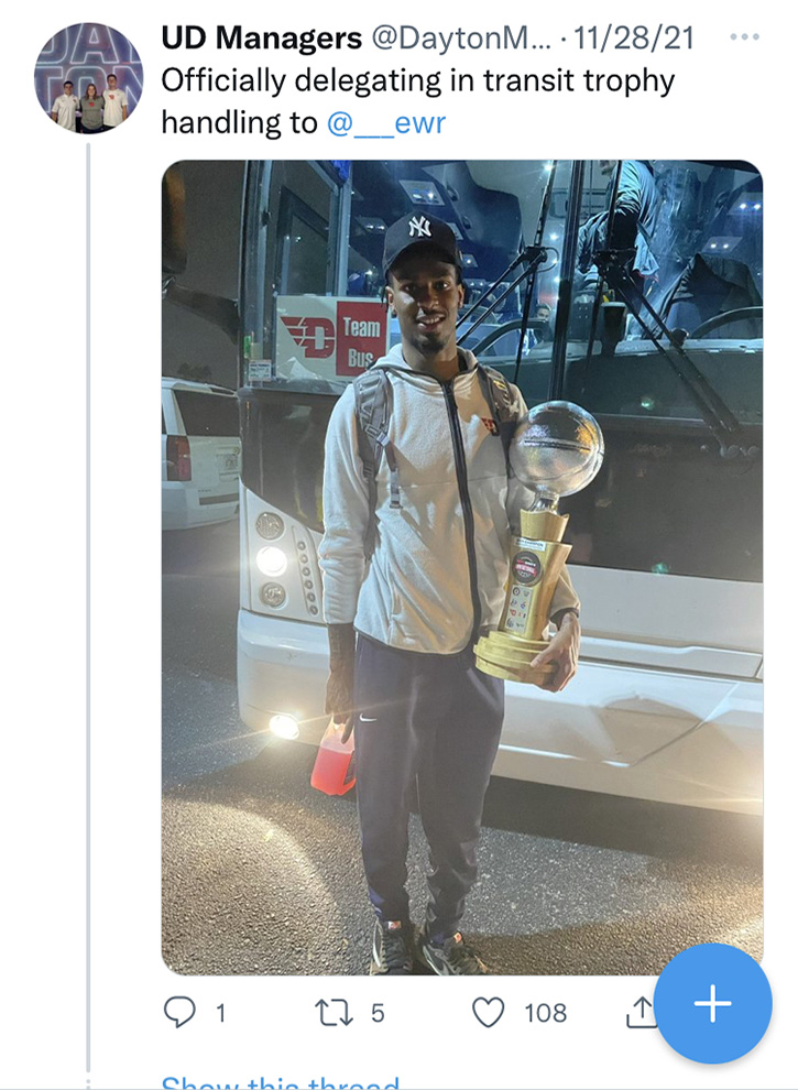 Carrying the trophy in front of the team bus