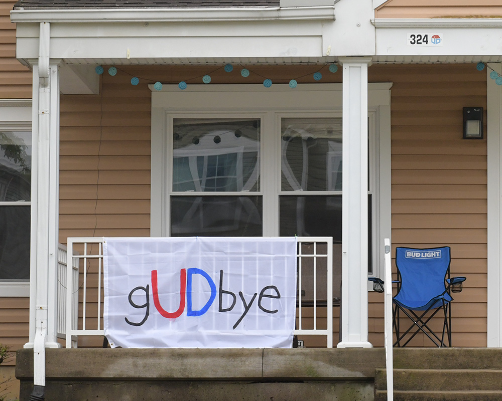 A sheet sign reading goodbye on a student house