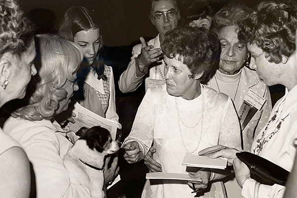 Erma Bombeck signing autographs for a group of women