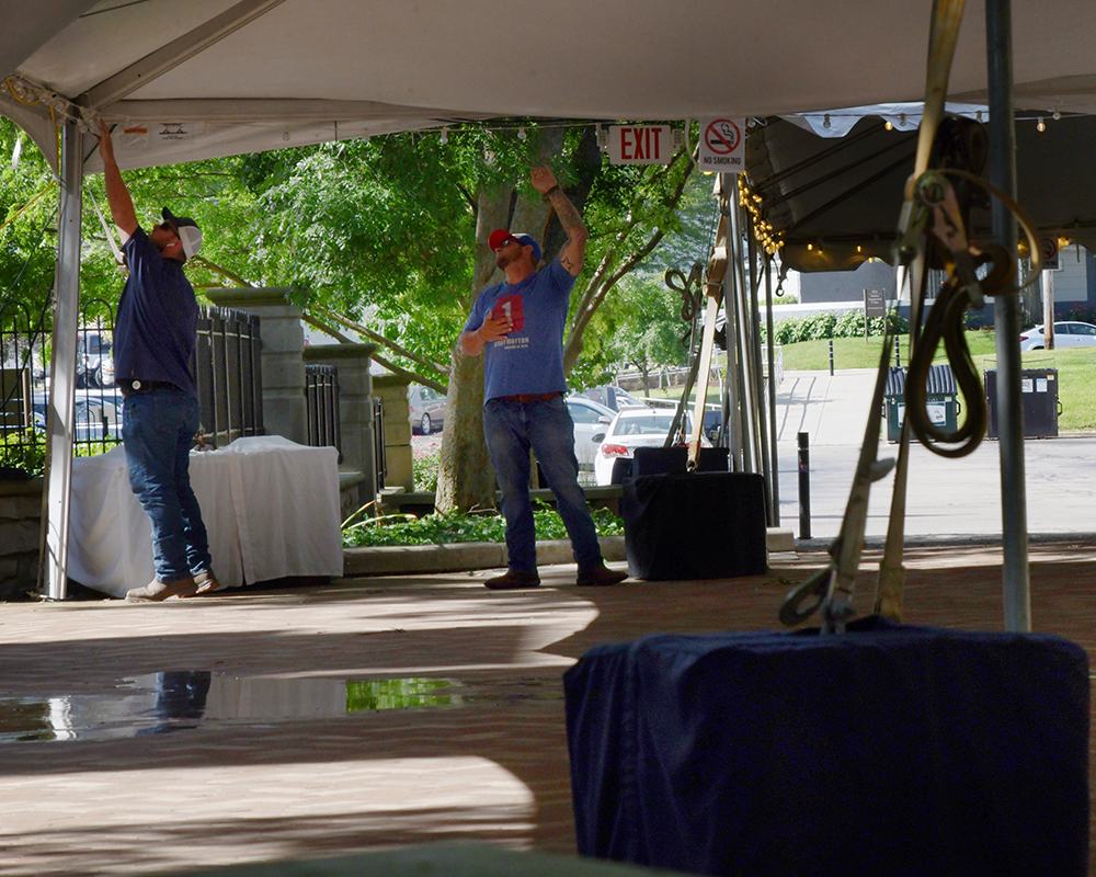 Workers set up a party tent